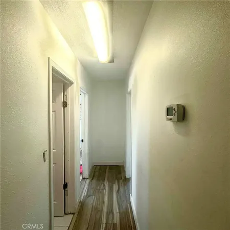 a bedroom with a bed and a flat tv screen on dresser