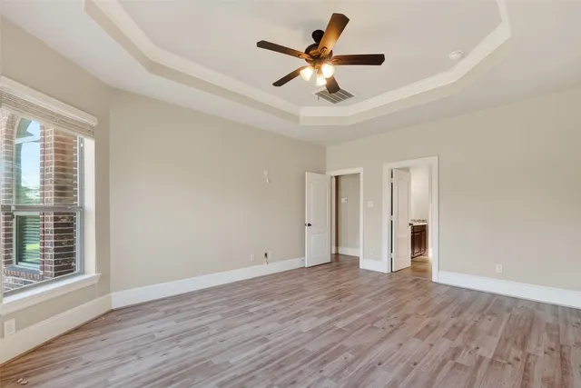 a view of empty room with wooden floor