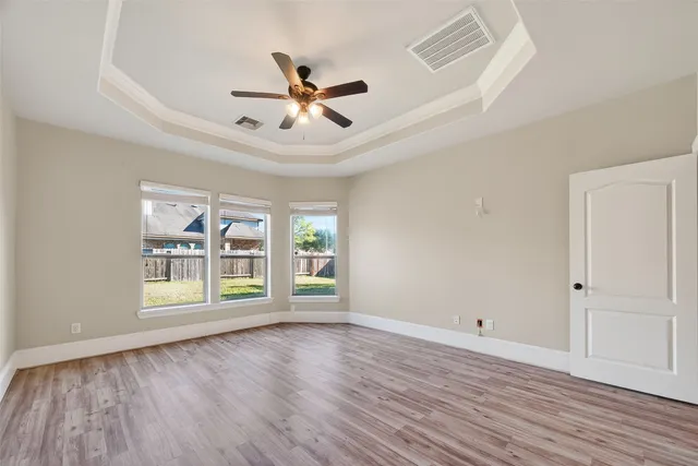 an empty room with windows and closet
