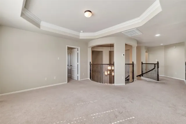 a view of an empty room with a window and closet area
