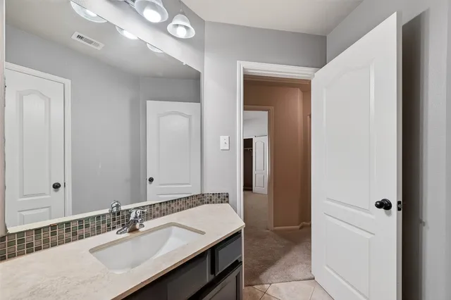 a view of a room with wooden floor fan and window