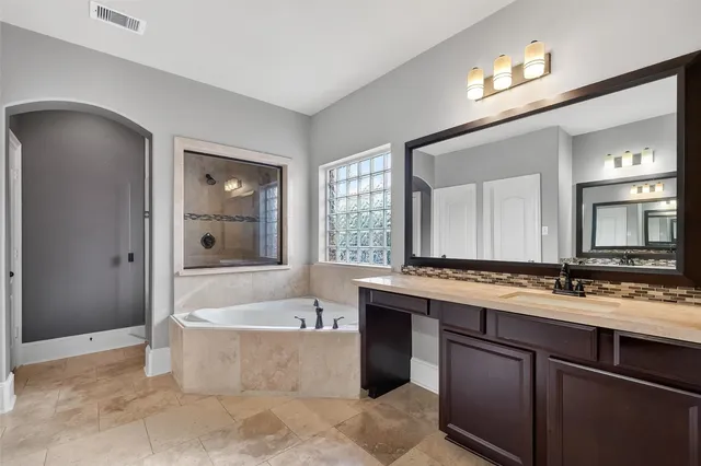 a view of a house with a yard and a large tree