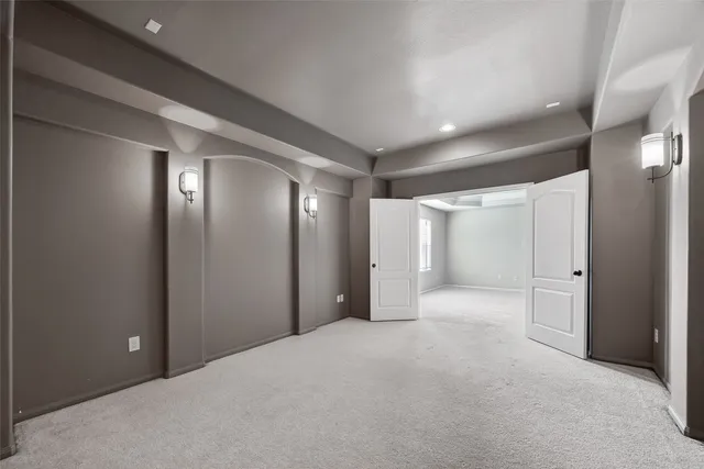 a large kitchen with stainless steel appliances kitchen island granite countertop a stove and a refrigerator