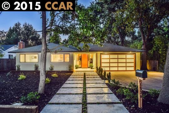 a view of a pathway house with potted plants and large trees