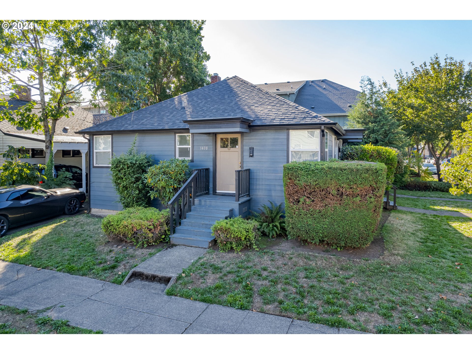 a front view of a house with a garden
