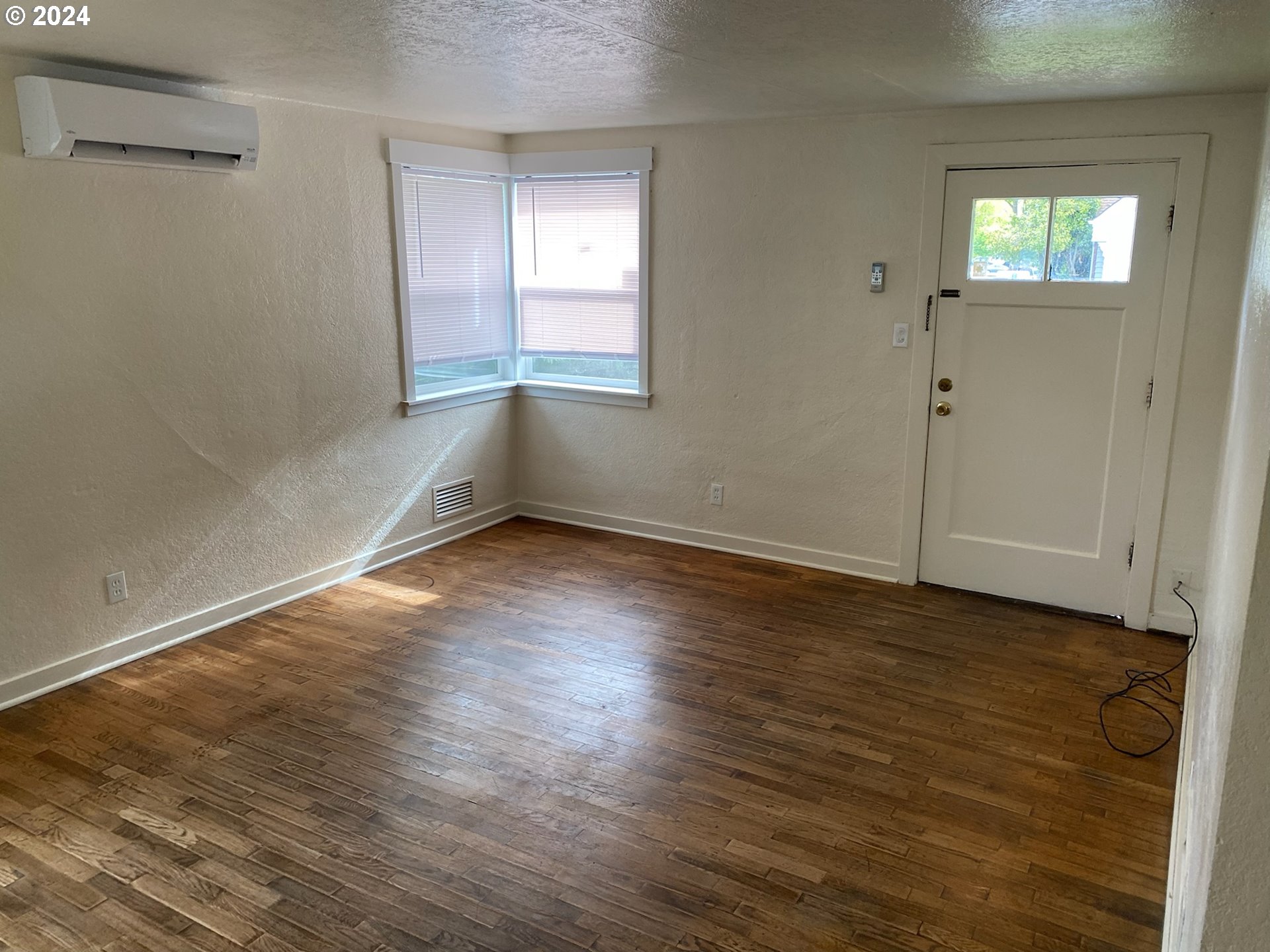 1408 Ferry Street Eugene, OR 97401 - Photo 11 of 20 an empty room with wooden floor and windows