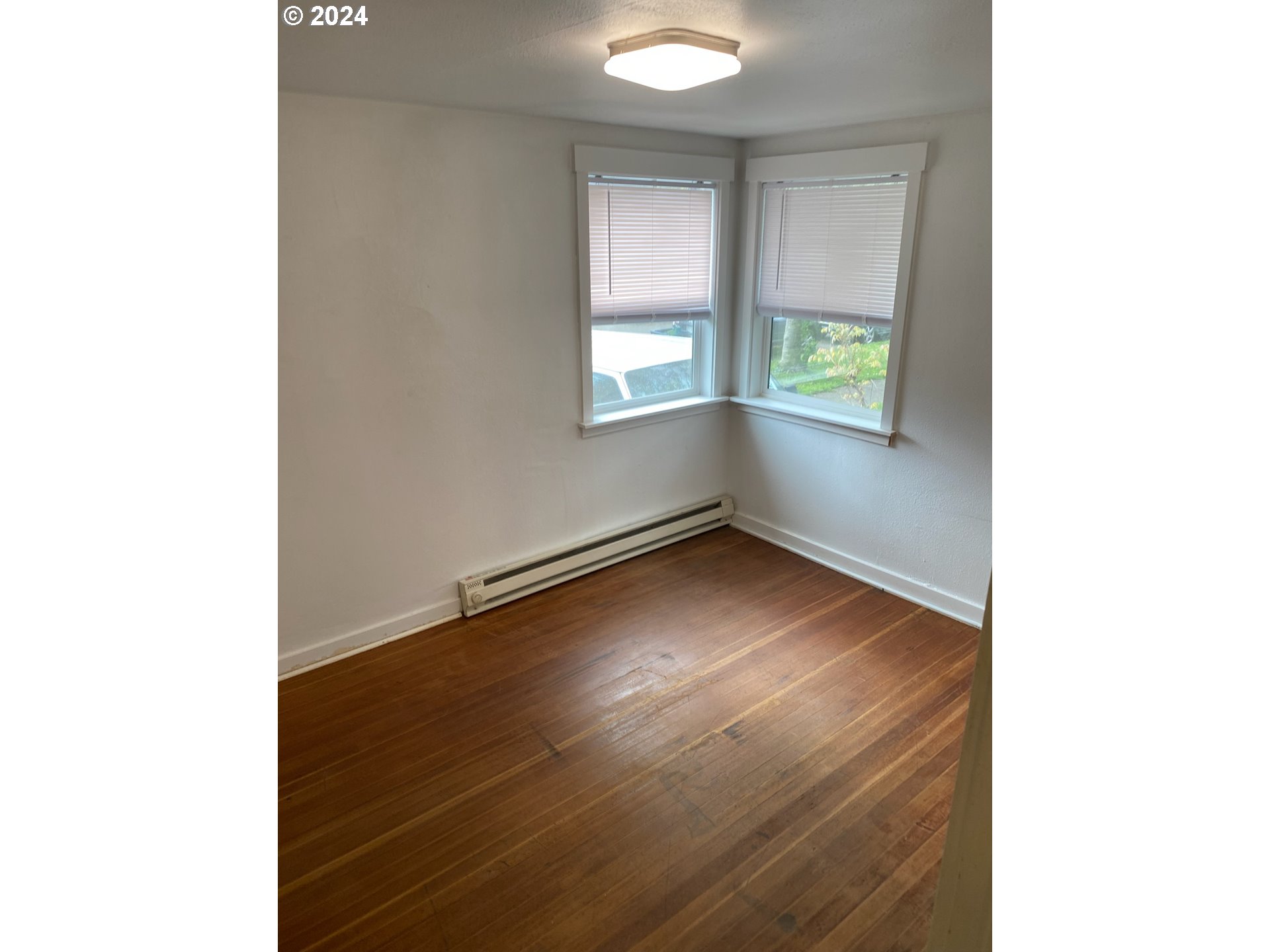 1408 Ferry Street Eugene, OR 97401 - Photo 16 of 20 a view of an empty room with wooden floor and a window