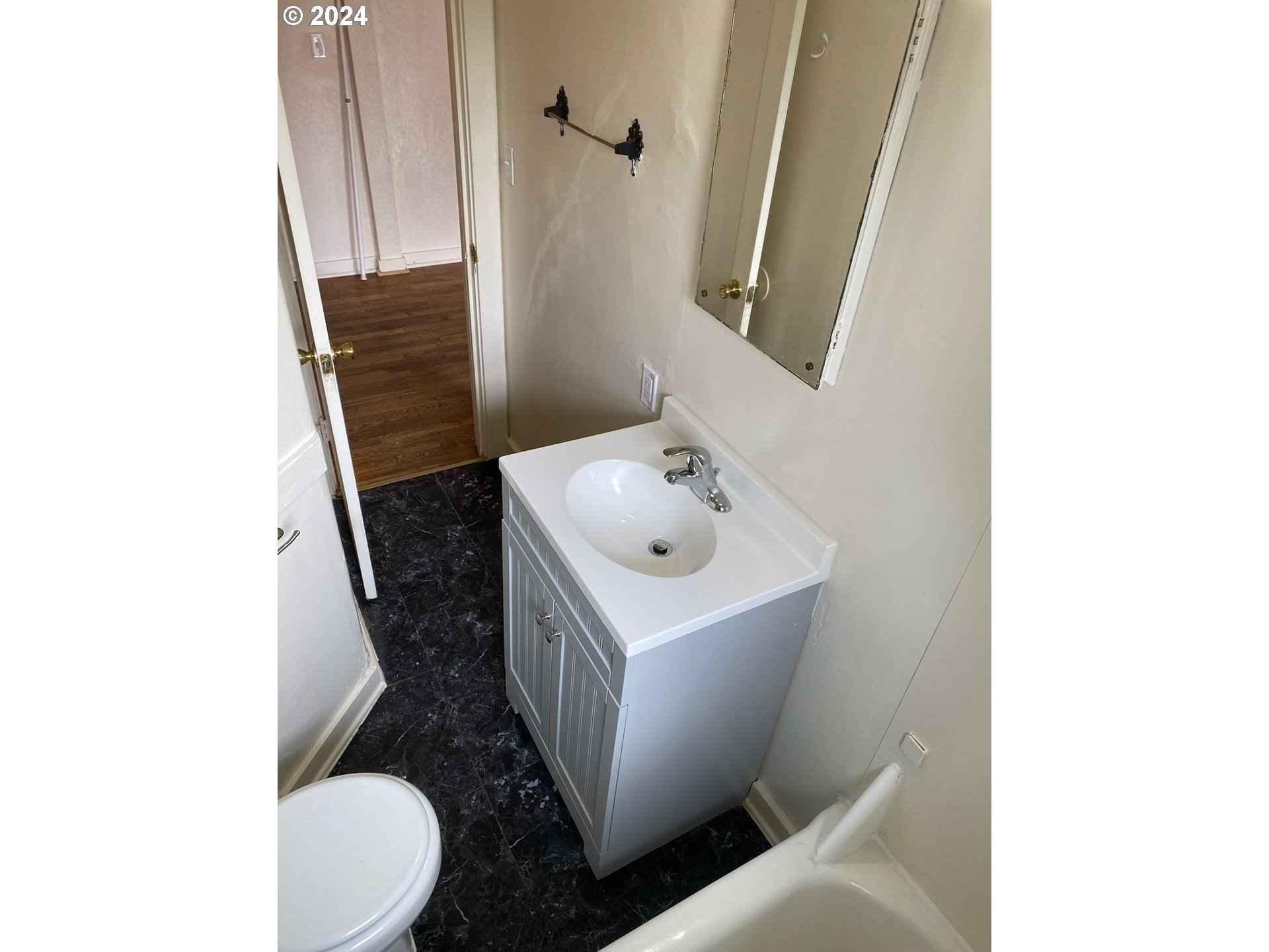 1408 Ferry Street Eugene, OR 97401 - Photo 19 of 20 a bathroom with a sink and mirror with toilet