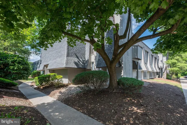 a front view of a house with a yard and a garden
