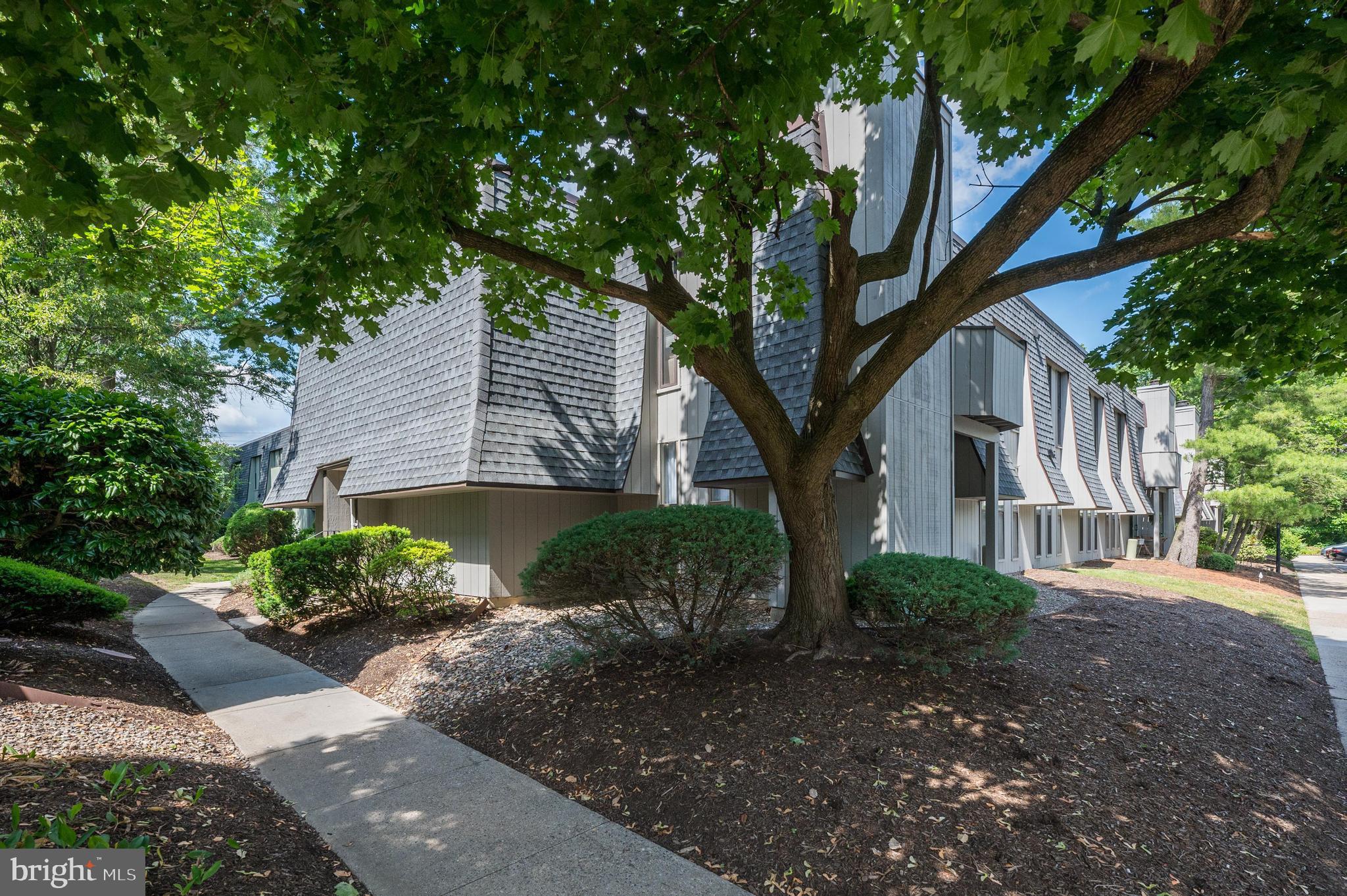 a front view of a house with a yard and a garden