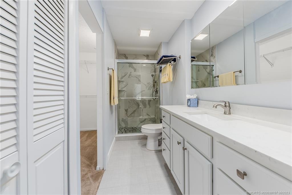 5413 Southeast Miles Grant Road, Unit G208 Stuart, FL 34997 - Photo 13 of 36 Master bath with its easy access shower and loads of storage