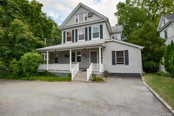 a front view of a house with a garden and porch
