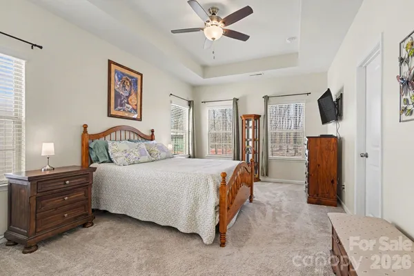 a bedroom with a bed dresser and a window