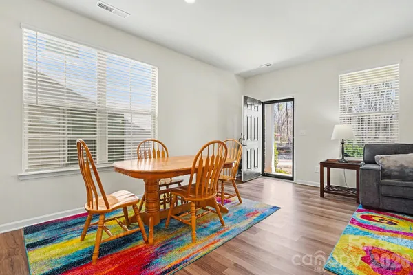 a very nice looking bedroom with furniture and wooden floor