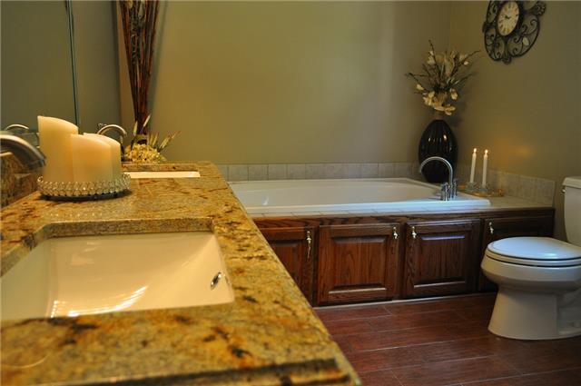 4424 Dugger Road Culleoka, TN 38451 - Photo 7 of 20 Master bathroom has granite counters and beautiful wood grain tile, which is one of the hottest trends in new homes.