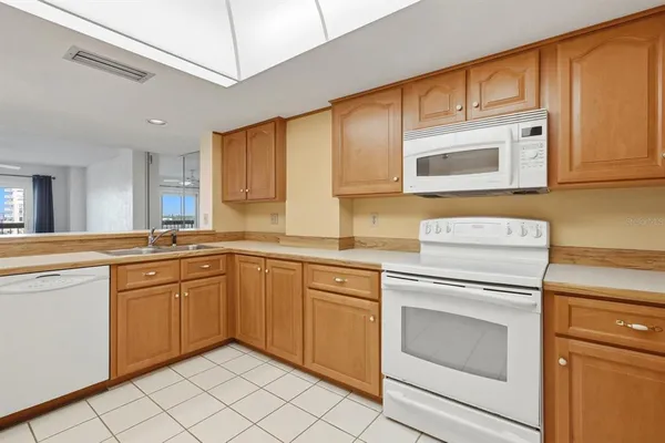 a kitchen with stainless steel appliances granite countertop a refrigerator sink and cabinets