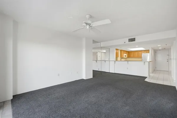 an empty room with a empty space and a ceiling fan
