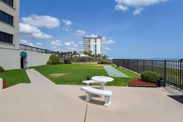 a view of roof deck with wooden floor and seating space