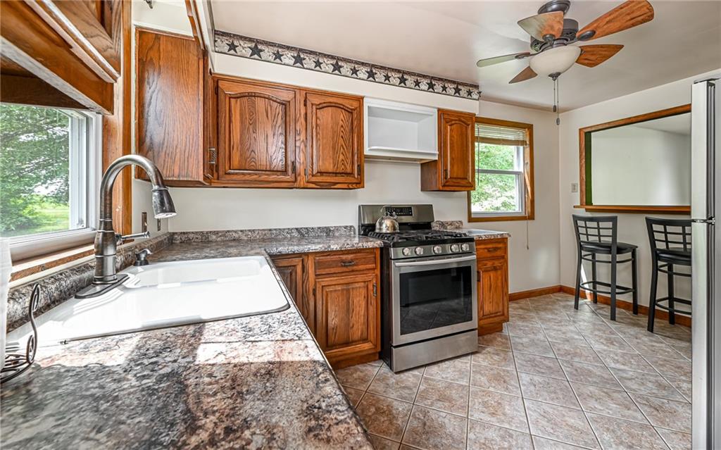 2760 Ridge Rd Extension Baden, PA 15005 - Photo 11 of 23 a kitchen with stainless steel appliances granite countertop a stove sink and cabinets