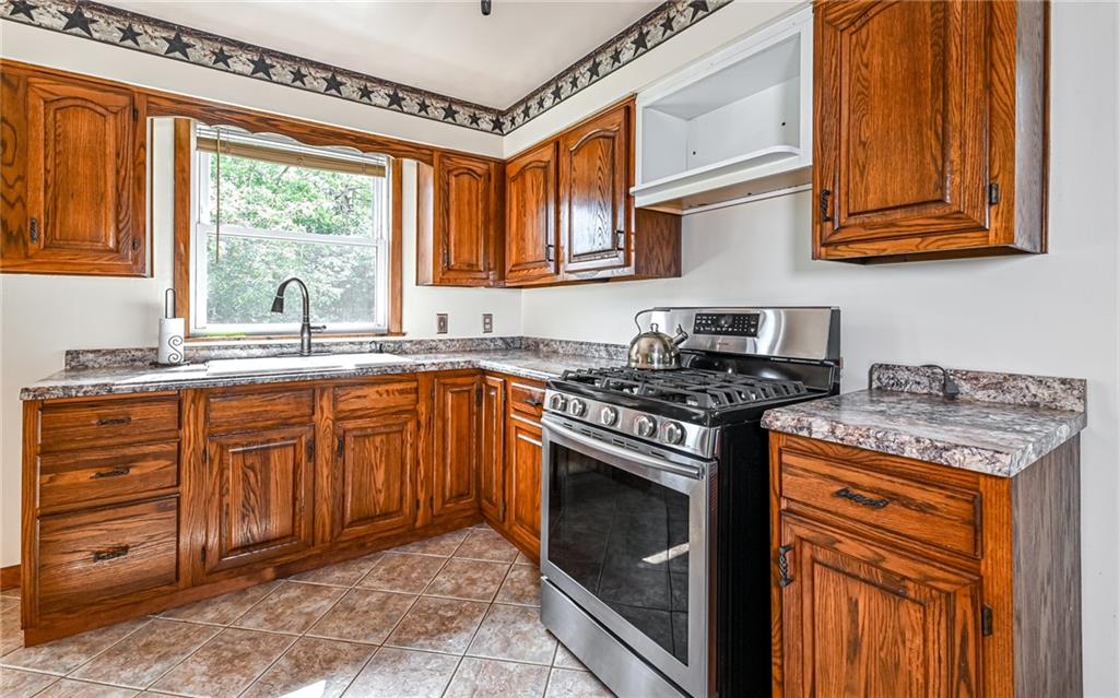 2760 Ridge Rd Extension Baden, PA 15005 - Photo 12 of 23 a kitchen with stainless steel appliances granite countertop a stove sink and cabinets