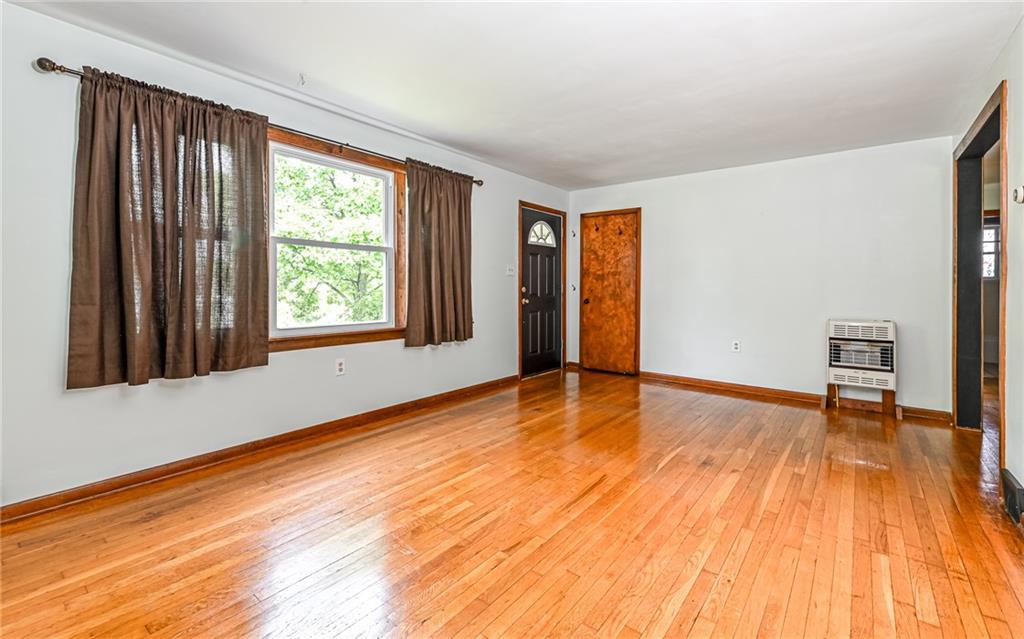 2760 Ridge Rd Extension Baden, PA 15005 - Photo 4 of 23 a view of an empty room with wooden floor and a window