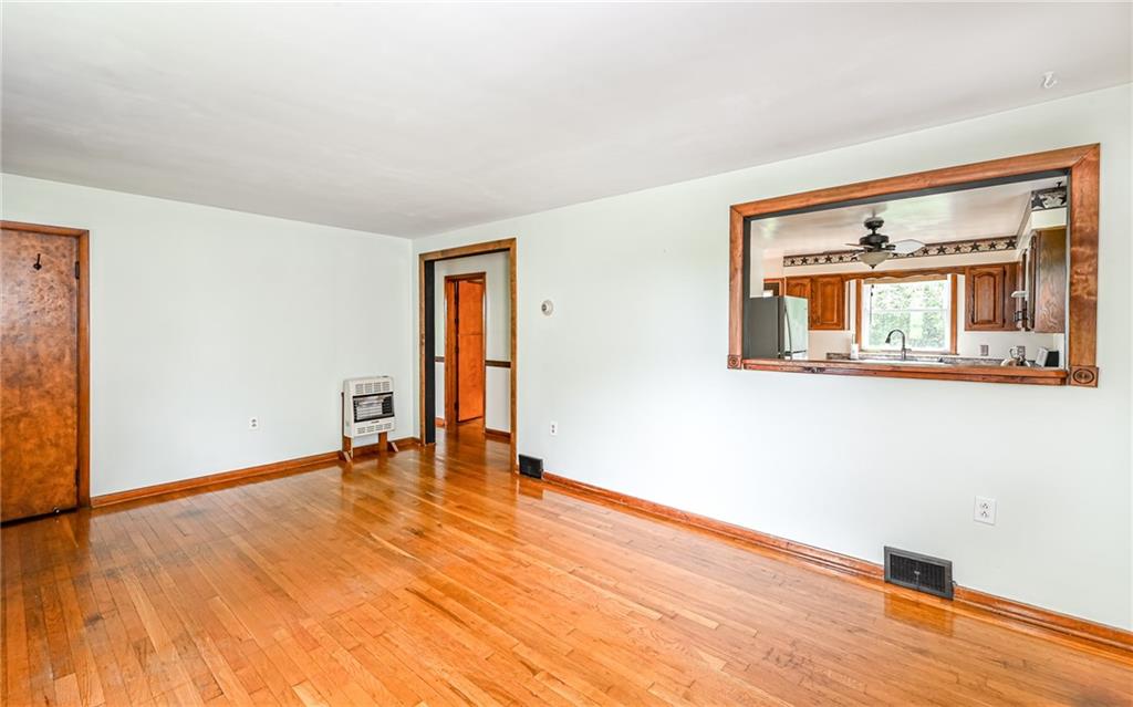 2760 Ridge Rd Extension Baden, PA 15005 - Photo 5 of 23 an empty room with wooden floor and a window