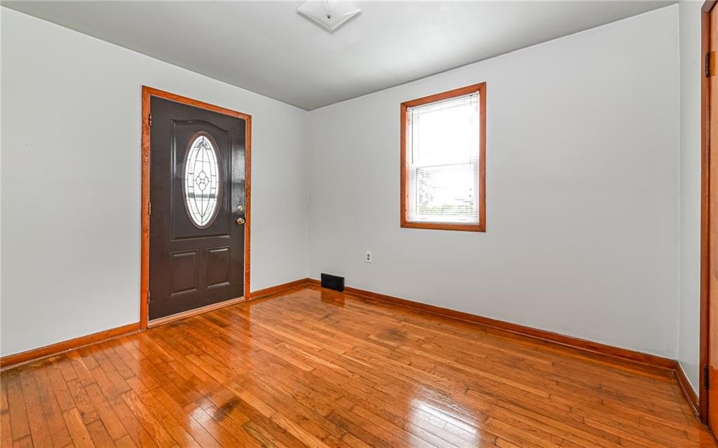 2760 Ridge Rd Extension Baden, PA 15005 - Photo 7 of 23 a view of an empty room with a window and wooden floor