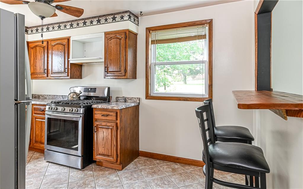 2760 Ridge Rd Extension Baden, PA 15005 - Photo 10 of 23 a kitchen with stainless steel appliances granite countertop a stove a sink and a refrigerator