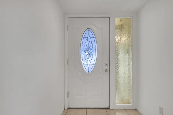 an empty room with a ceiling fan and a window