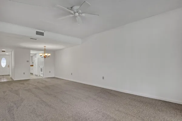 a view of an empty room with a chandelier