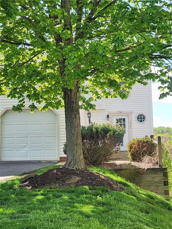 2000 Arbor Ridge Court Cheswick, PA 15024 - Photo 1 of 26 a view of a backyard with plants and large tree