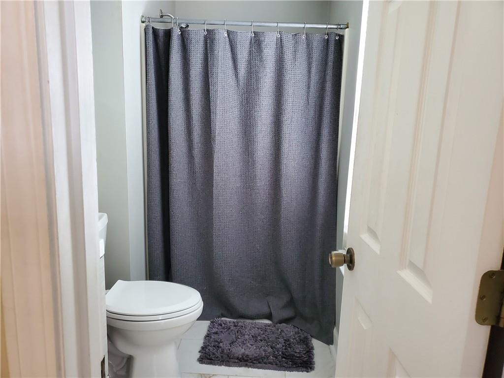 2000 Arbor Ridge Court Cheswick, PA 15024 - Photo 13 of 26 a bathroom with a shower curtain and a toilet