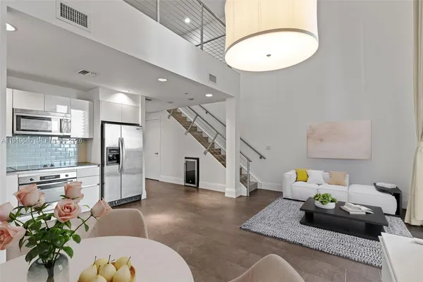 a living room with furniture and a chandelier