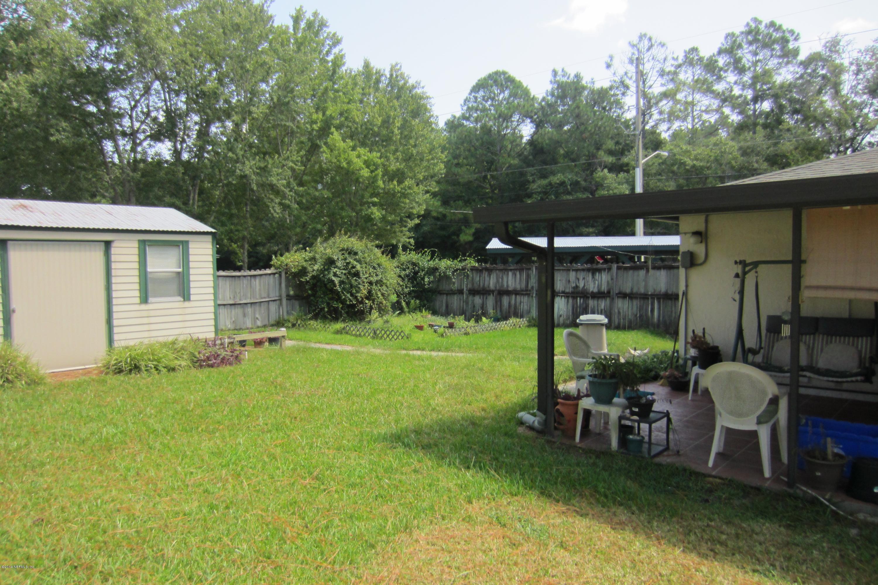 1936 Blair Road Jacksonville, FL 32221 - Photo 11 of 14 a view of a chair and table in backyard of the house