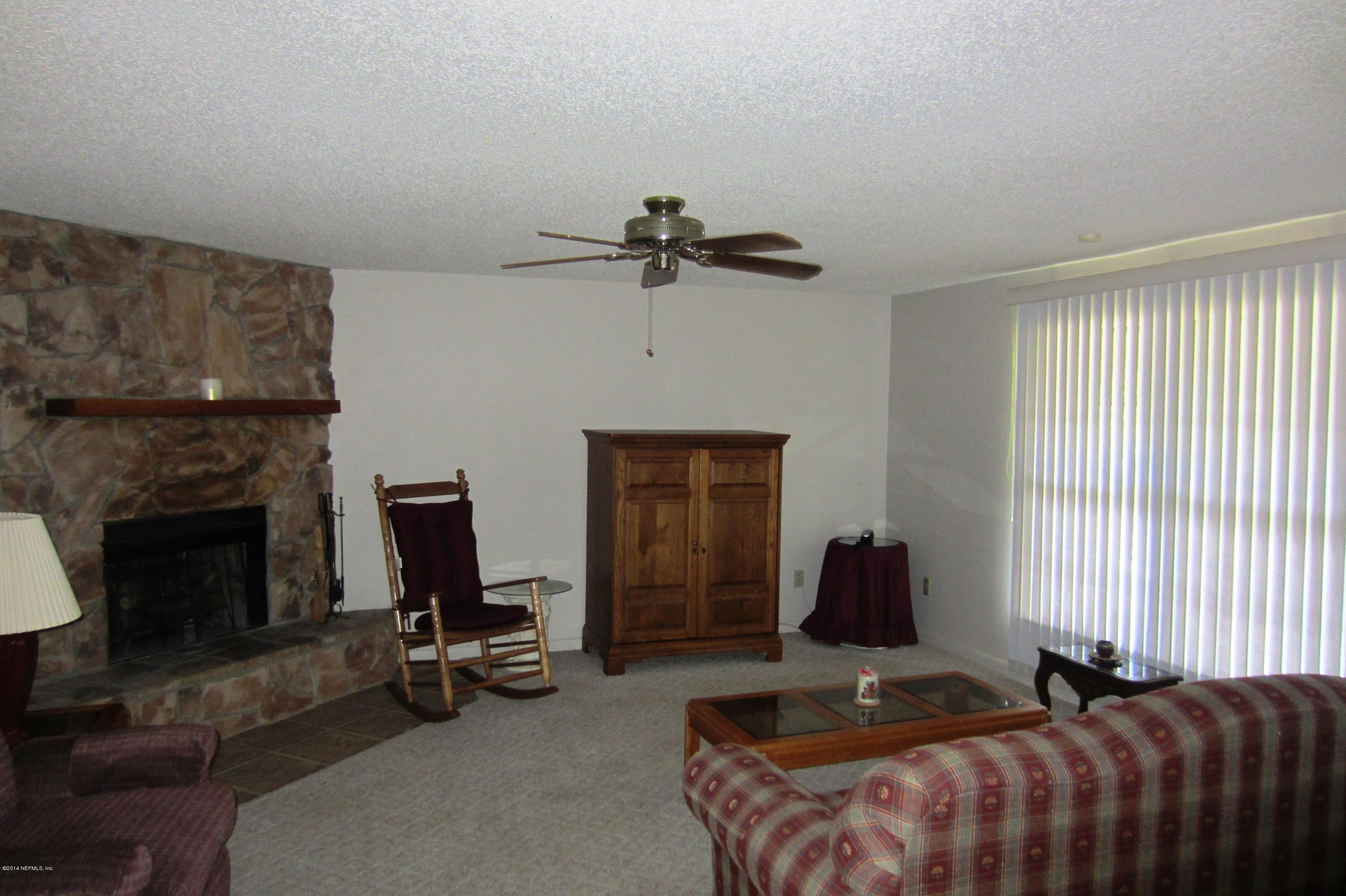 1936 Blair Road Jacksonville, FL 32221 - Photo 2 of 14 a bedroom with furniture a bed and a fireplace