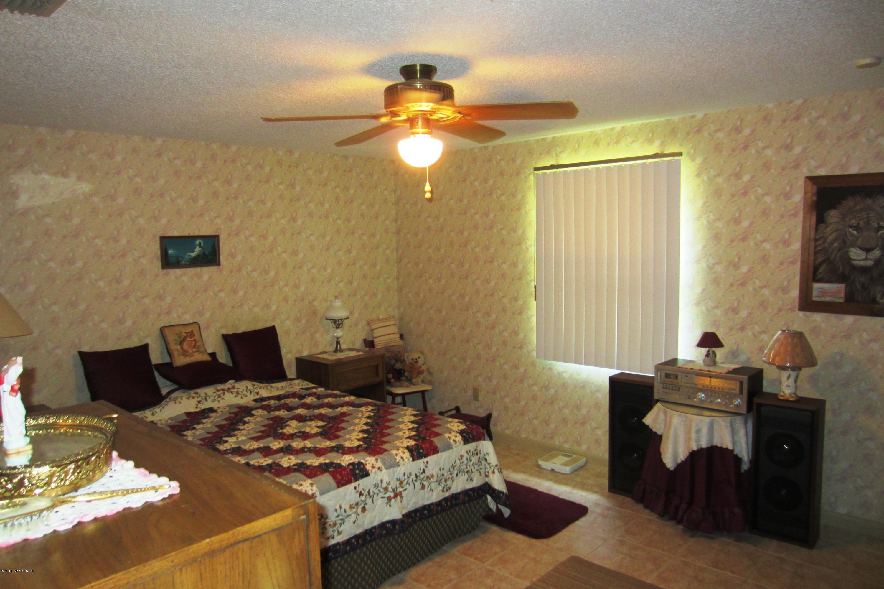 1936 Blair Road Jacksonville, FL 32221 - Photo 6 of 14 a bedroom with a bed and wooden floor
