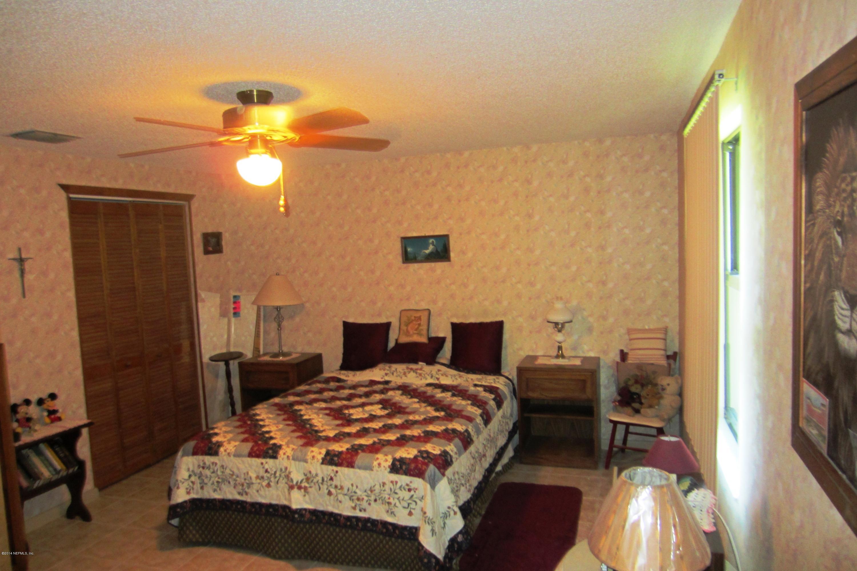 1936 Blair Road Jacksonville, FL 32221 - Photo 7 of 14 a bedroom with a bed and a chandelier