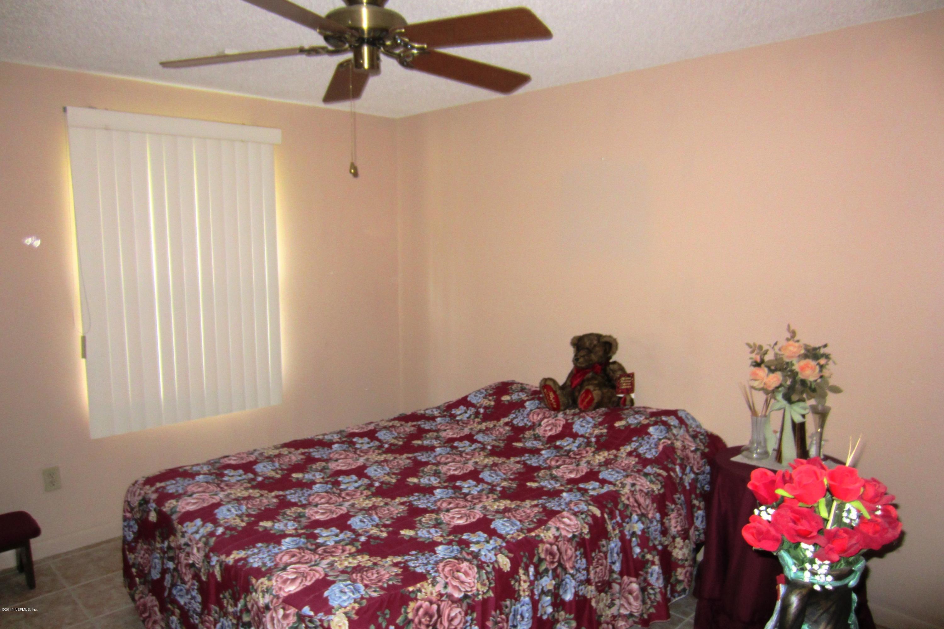 1936 Blair Road Jacksonville, FL 32221 - Photo 8 of 14 a bedroom with a bed and a chandelier