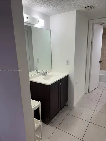 a bathroom with a sink vanity and mirror