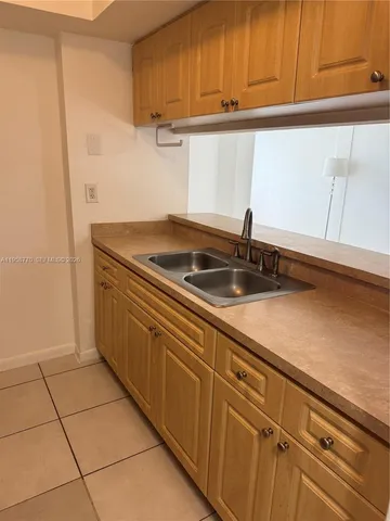 a kitchen with granite countertop a sink and cabinets