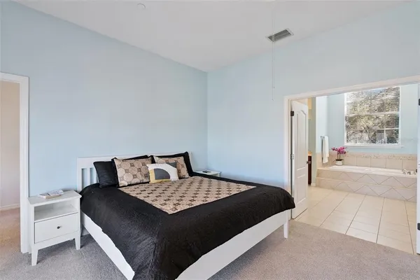 a bedroom with a large bed and a couch