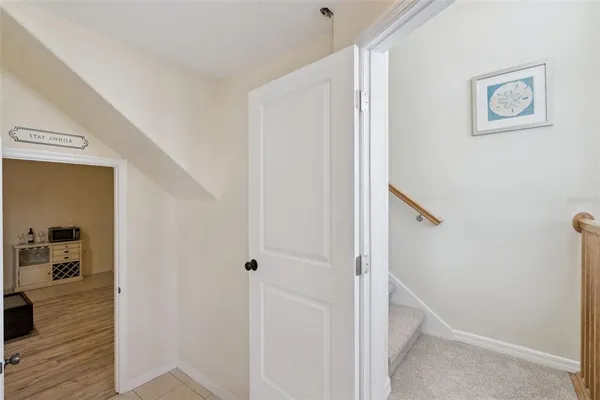 a view of a hallway with wooden floor and closet