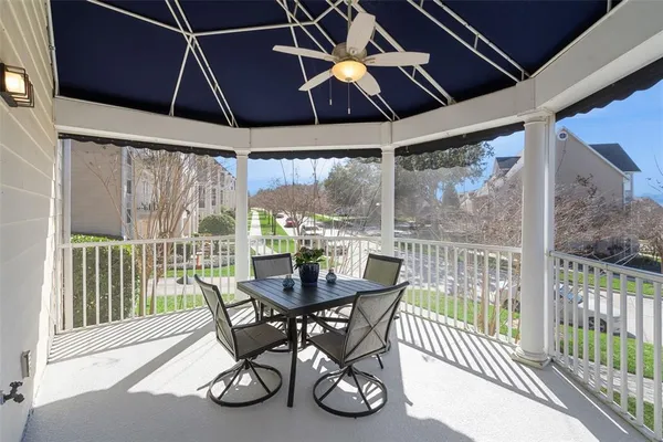 a dining room with furniture water view and a floor to ceiling window