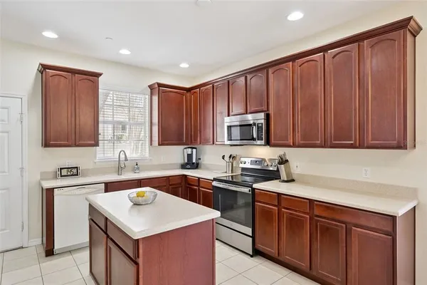 a kitchen with stainless steel appliances granite countertop a sink stove and cabinets