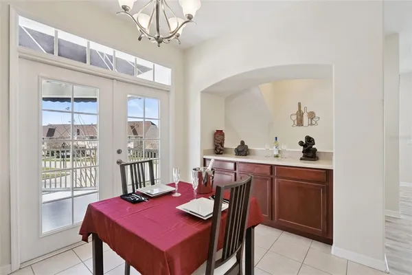 a view of a dining room with furniture and a chandelier