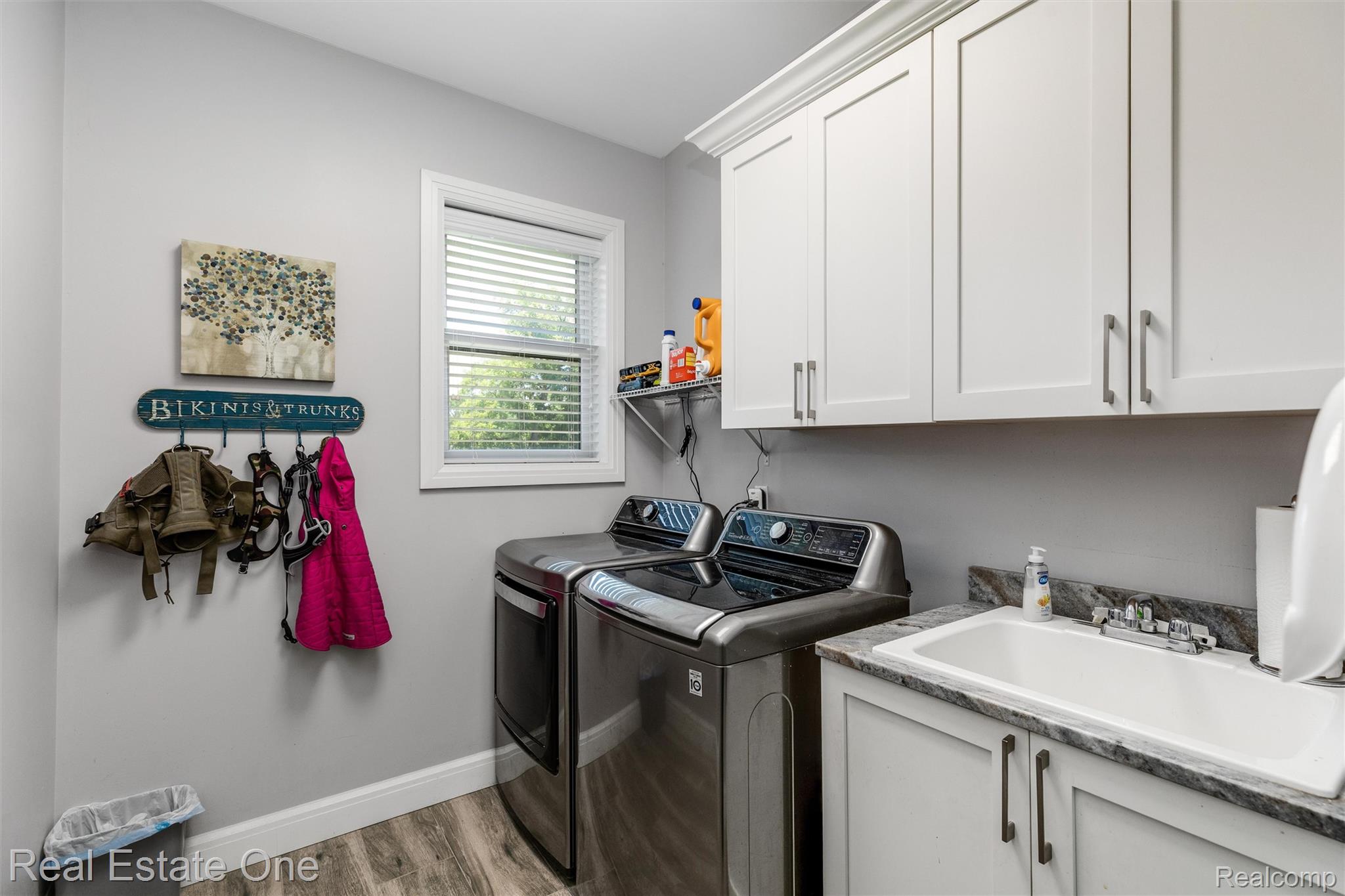 2983 28 Mile Road Washington, MI 48094 - Photo 6 of 54 Dedicated laundry area featuring wood-finish flooring, light grey walls, and a window with blinds