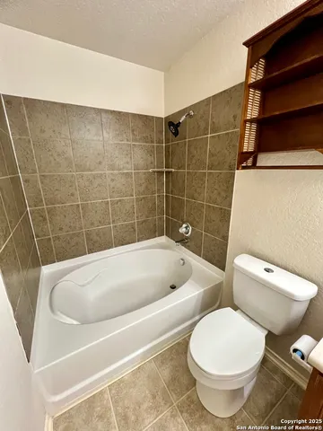 a bathroom with a toilet and bathtub