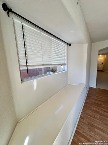 a view of a room with wooden floor
