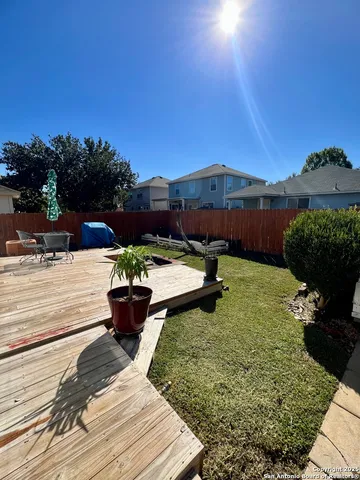 a view of a back yard of the house and front view of a house
