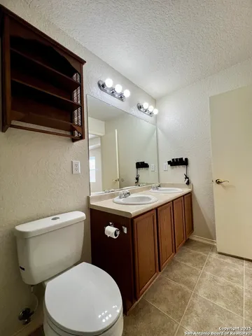 a bathroom with a toilet sink and mirror